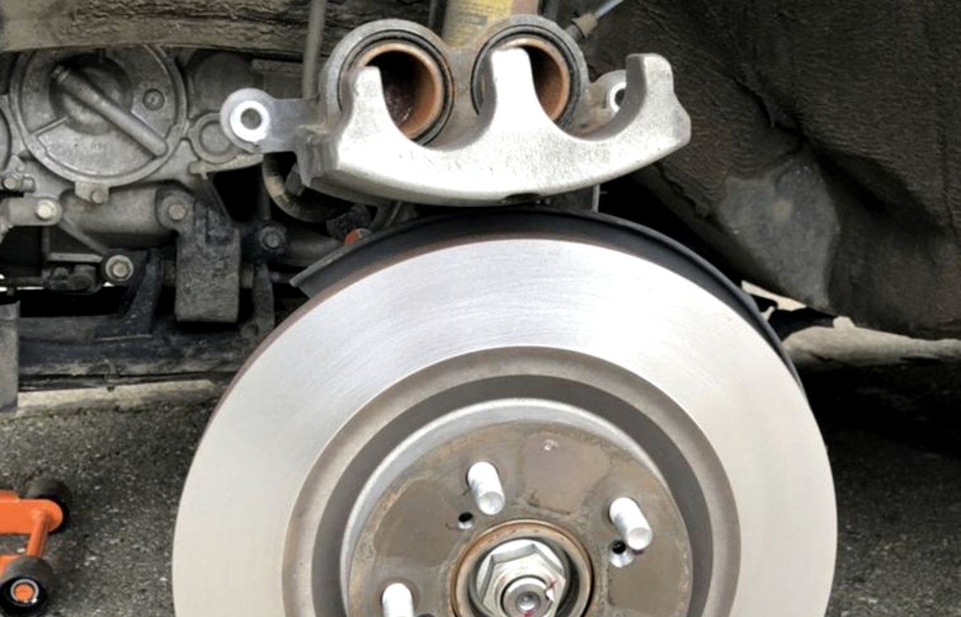 Fresh rotor and bracket going together at a Lake Charles brake service
